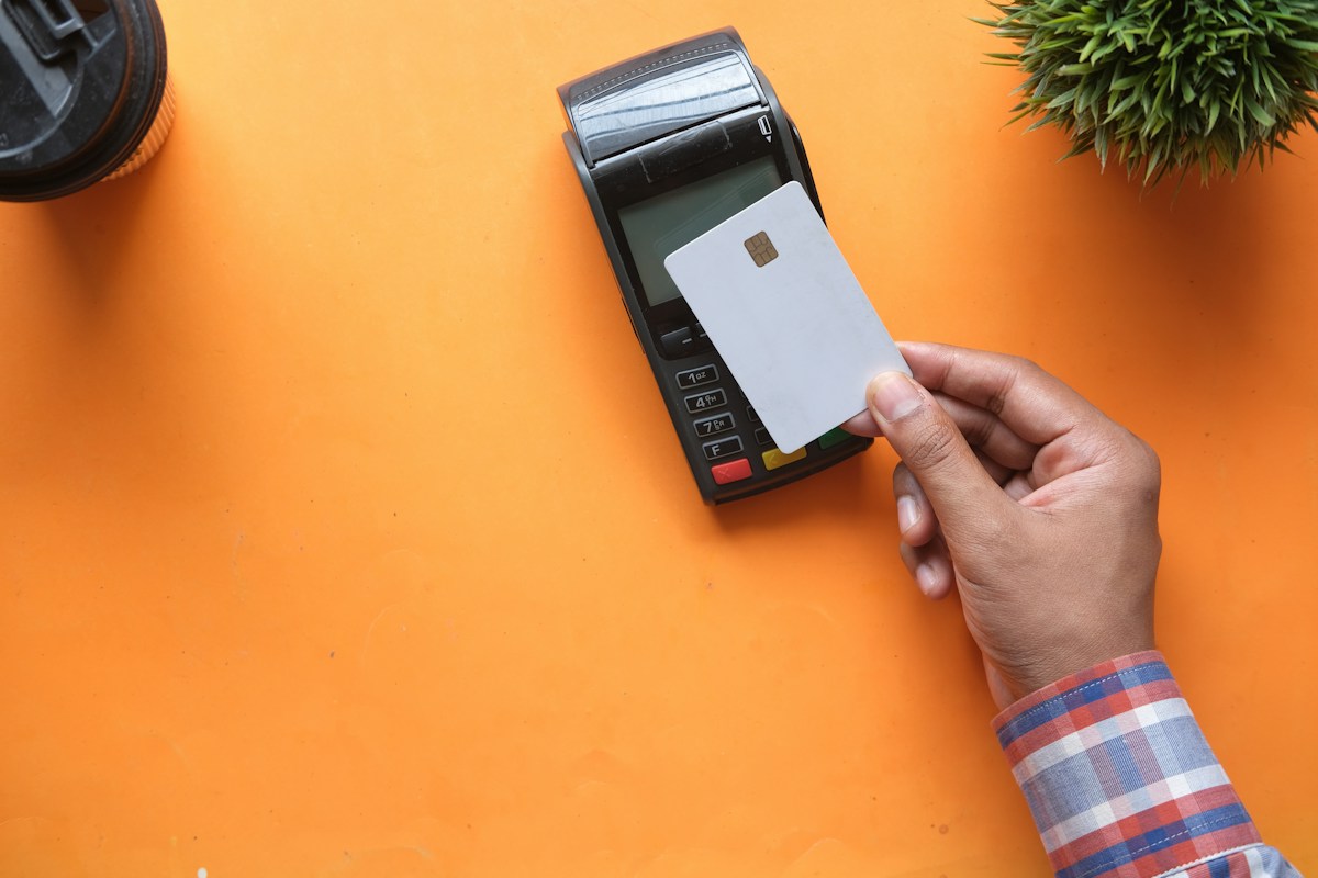 A card held up to a payment terminal