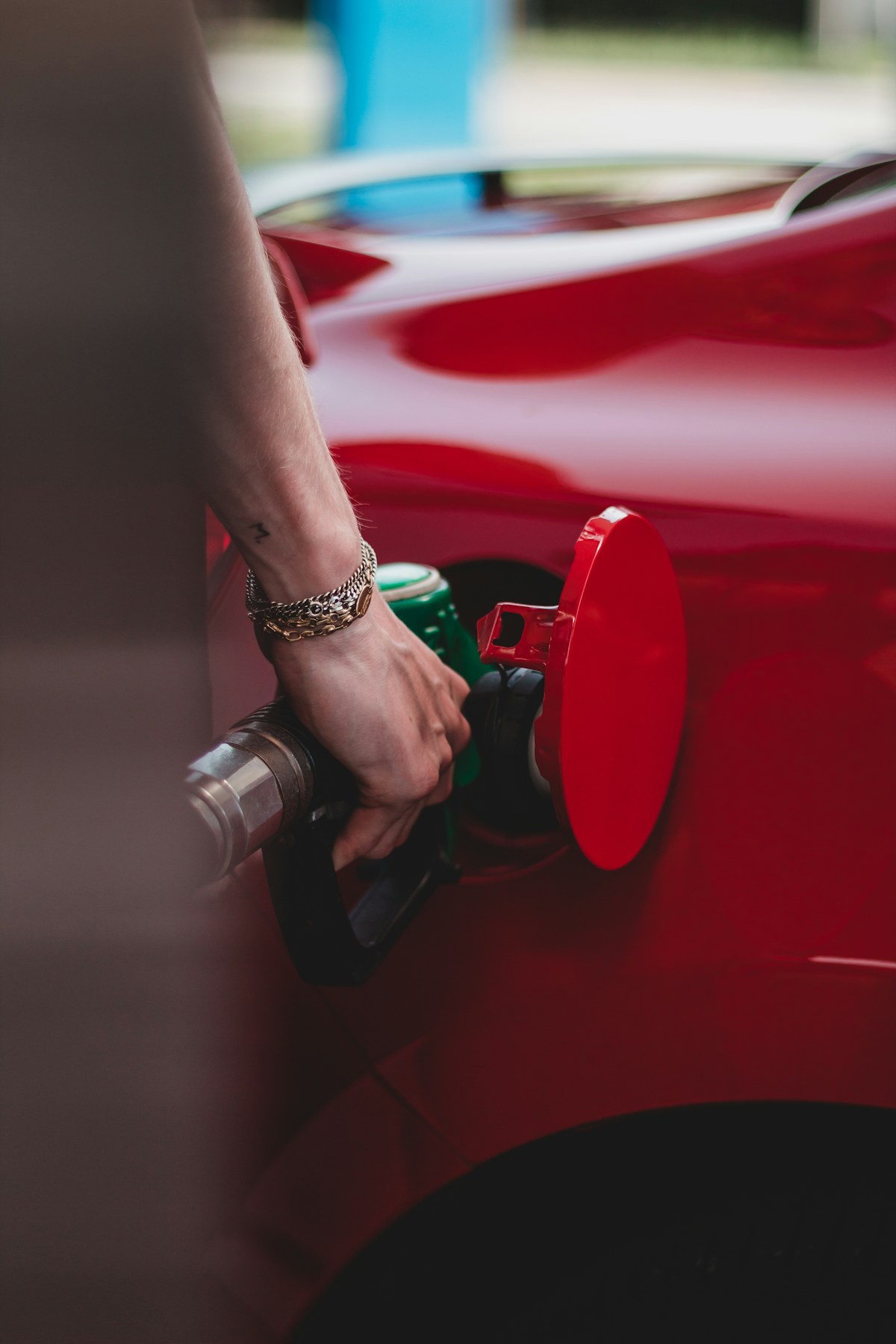 A driver refuelling a car at the pump