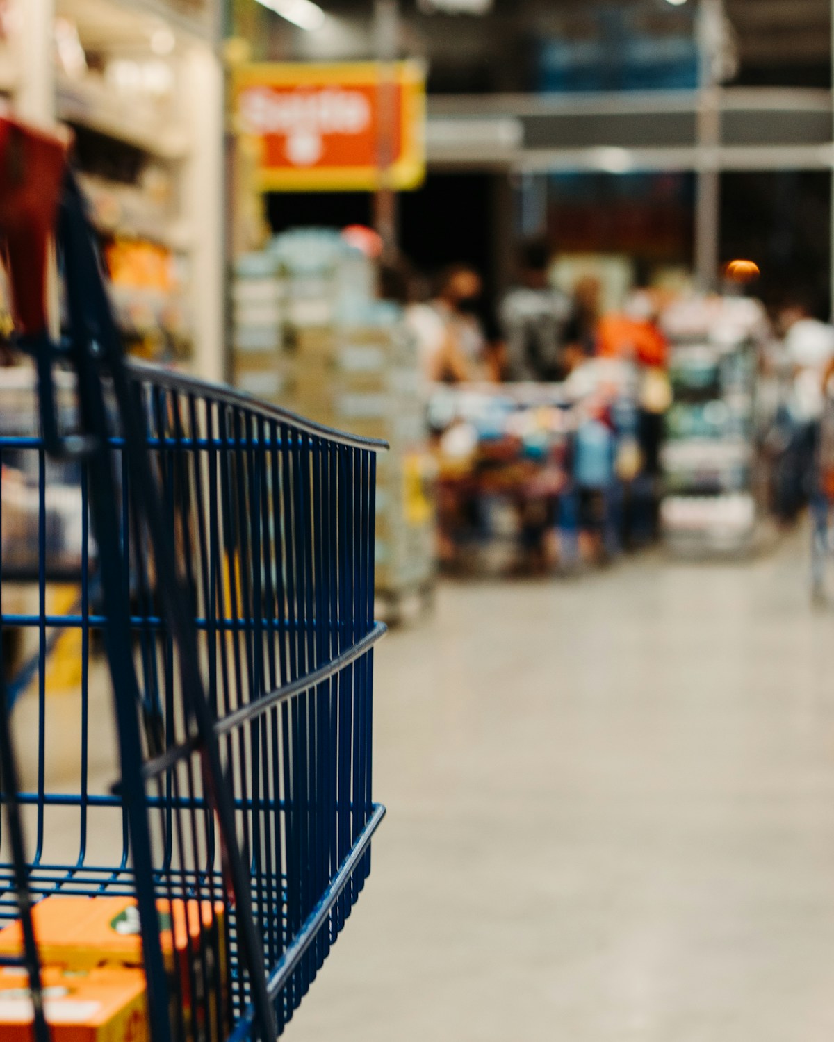 A shopping cart in a supermarket aisle